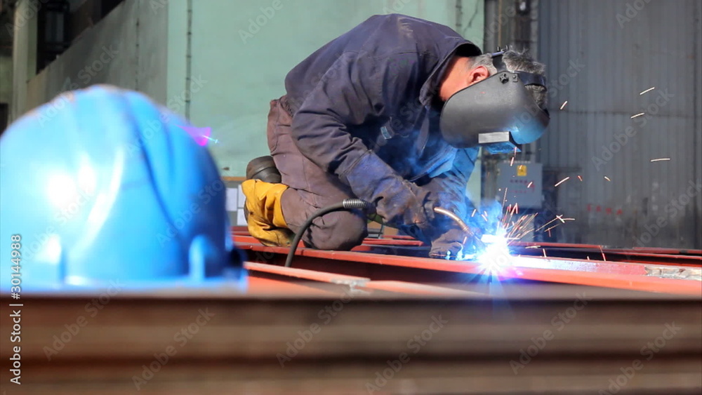Welder at work in factory Welder at work in factory