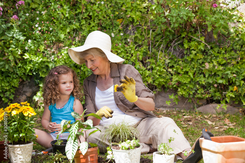 Wallpaper Mural Happy Grandmother with her granddaughter working in the garden Torontodigital.ca