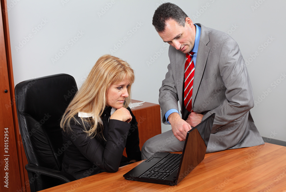 Fototapeta premium Businessman and businesswoman analyze the revenue