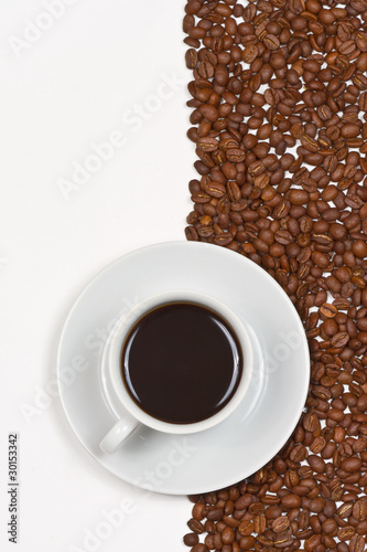 Coffee in white cup on saucer placed cofee beans