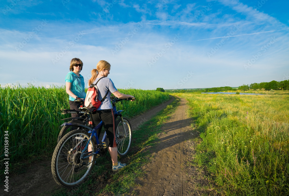 two girls relax biking