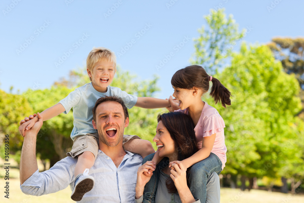 Parents giving  children a piggyback