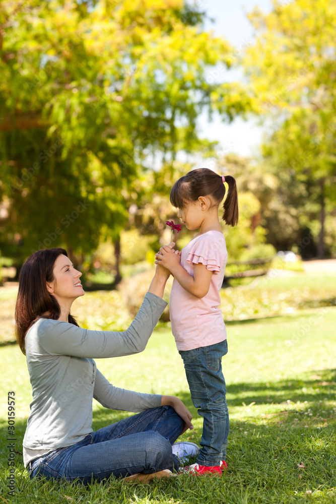 Fototapeta premium Joyful mother with her daughter in the park