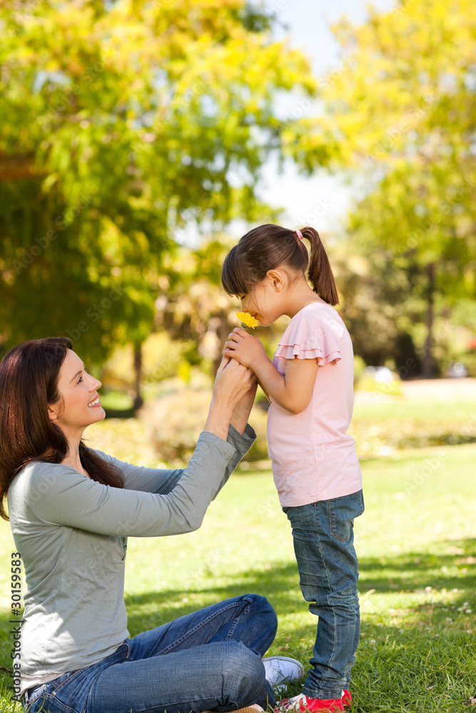 Beautiful mother with her daughter in the park Beautiful mother with her daughter in the park