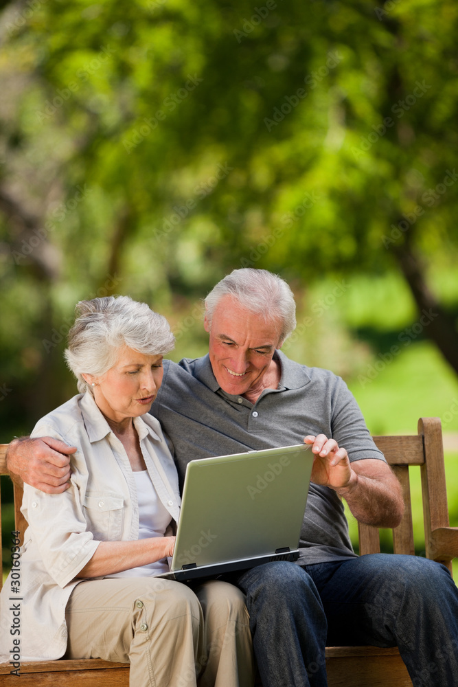 Elderly couple looking at their laptop Elderly couple looking at their laptop