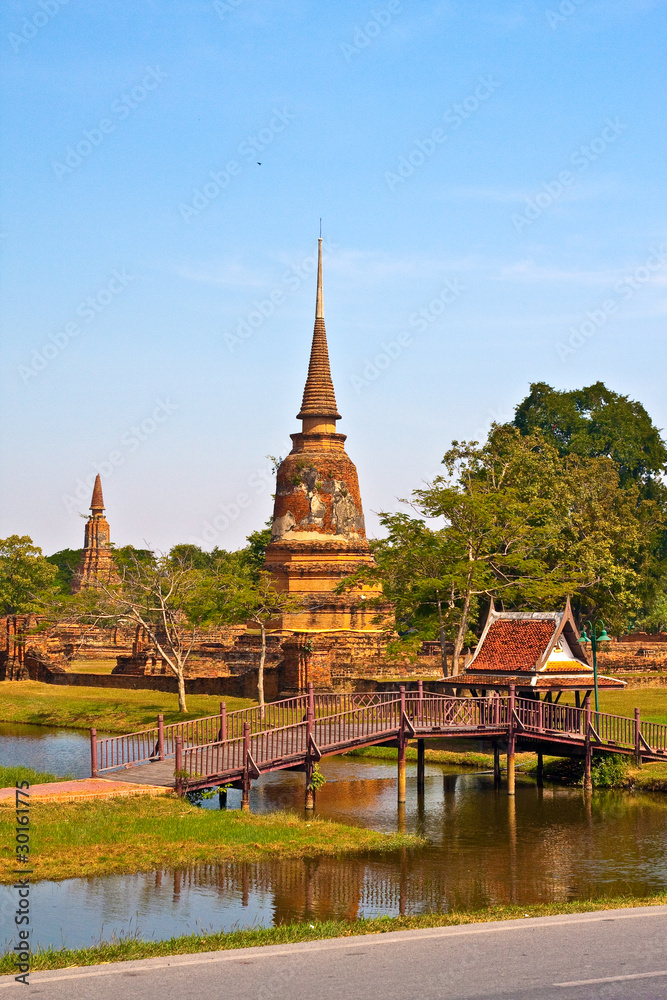 Ancient pagoda in Ayutthaya with lake vertical