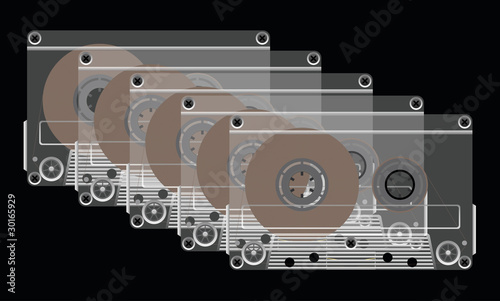 Compact cassettes on a black background.