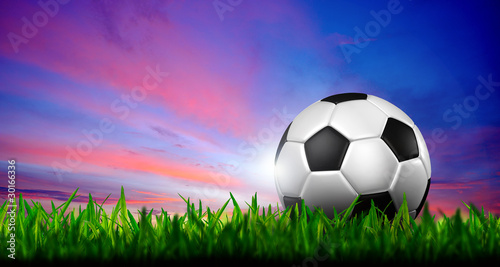 football in green grass over a twilight sky © kanate