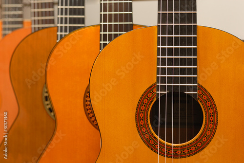 Row of classical acoustic guitars in musical store. Close-up vie