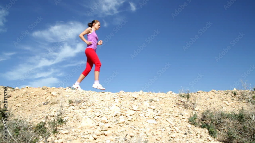 Young woman jogging in the desert, slow motion, shot at 60fps Young woman jogging in the desert, slow motion, shot at 60fps