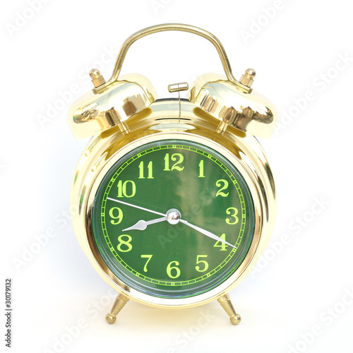 Gold old style alarm clock on white background