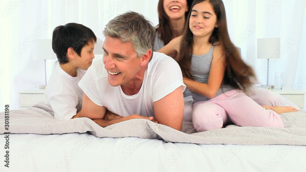 Children tickling their father Children tickling their father