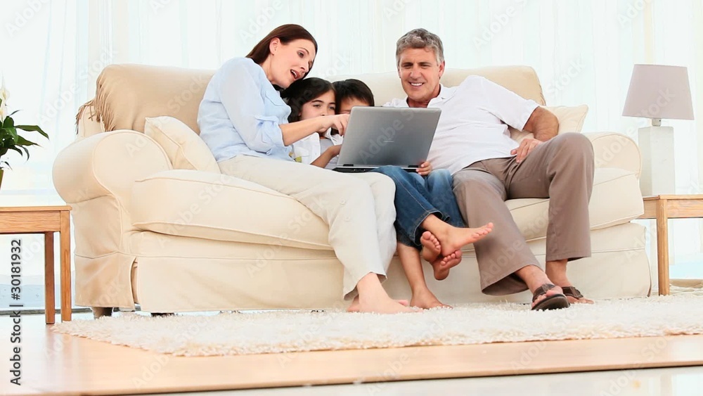 Family looking at a laptop Family looking at a laptop