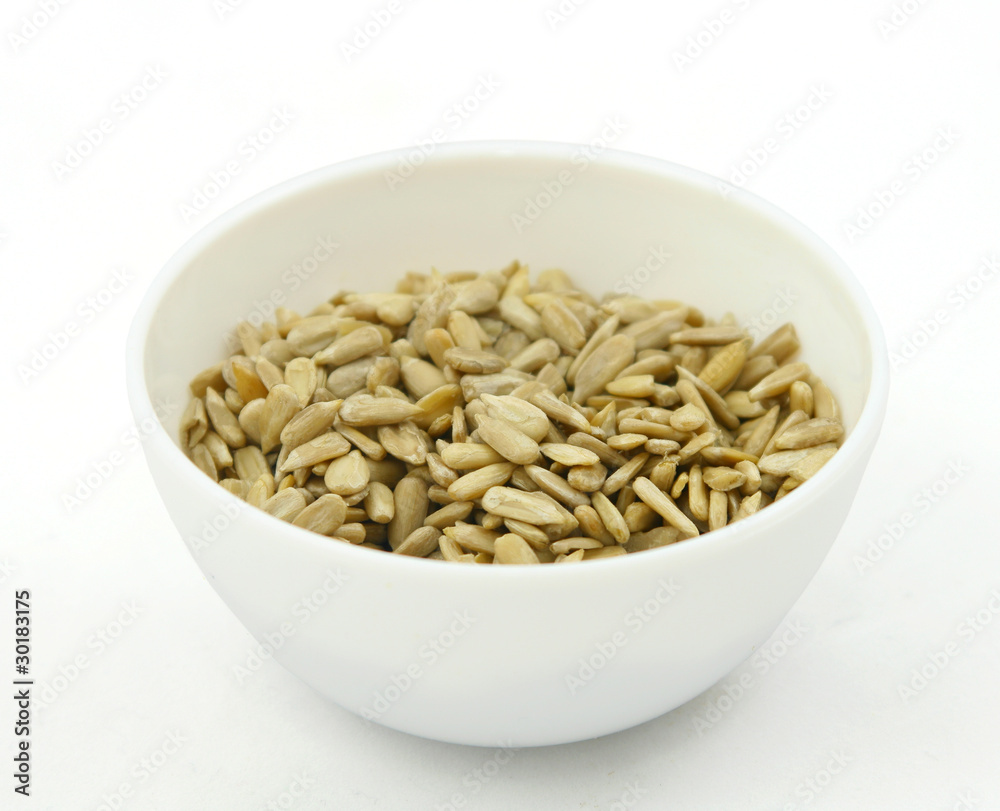Sunflower seeds in a white bowl Sunflower seeds in a white bowl