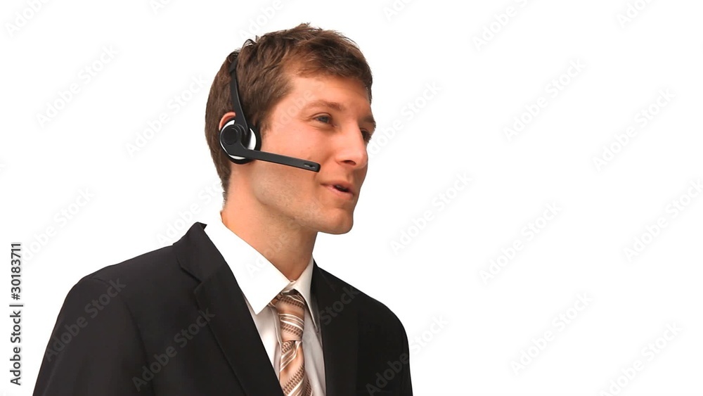 Young businessman speaking over the headset Young businessman speaking over the headset