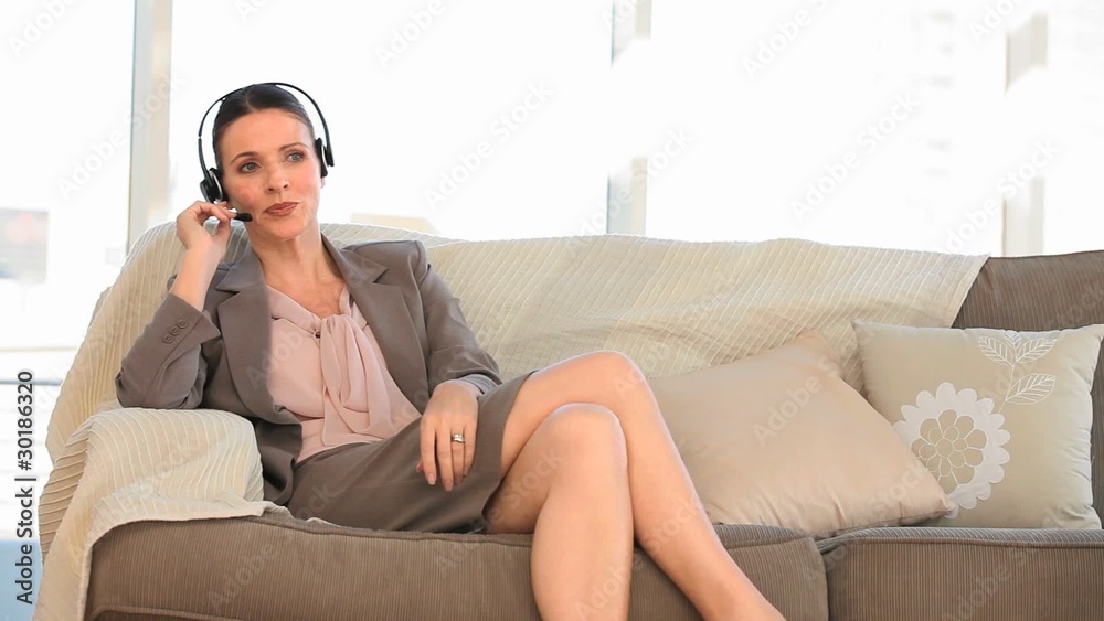 Casual woman speaking over the headset Casual woman speaking over the headset