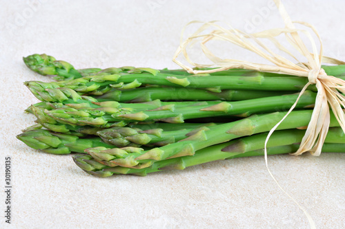 Fresh organic asparagus bunch tied with raffia