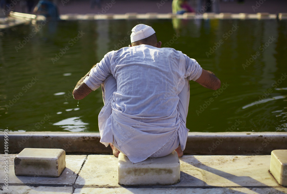 Muslim man performing a wudu before praying