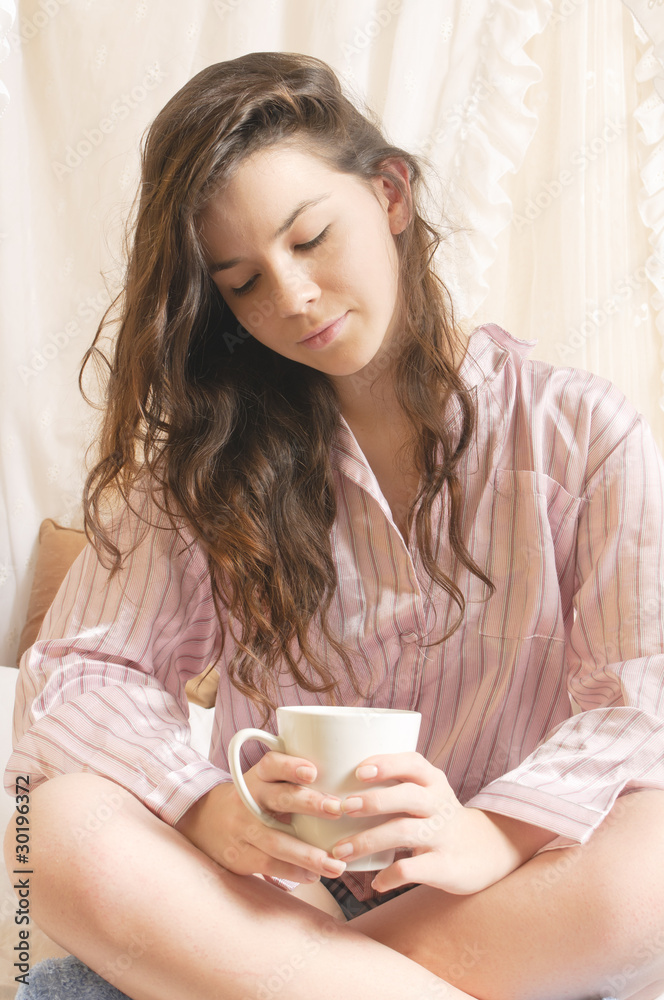Mädchen mit Kaffeebecher im Bett Mädchen mit Kaffeebecher im Bett
