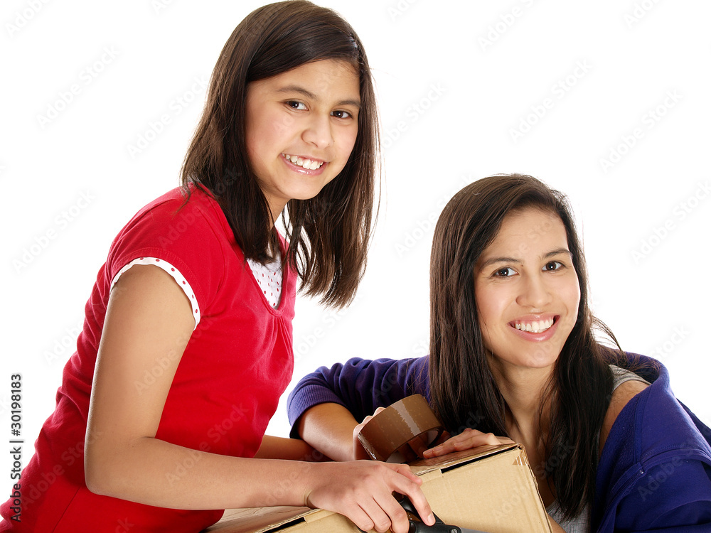 smiling girls packing a box