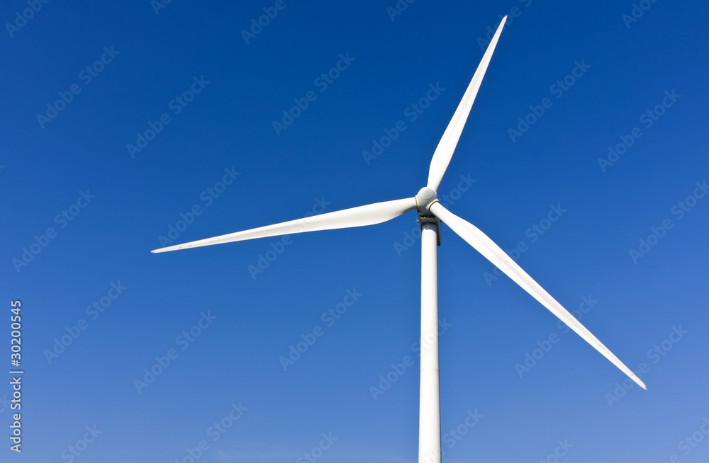 White wind turbine generating electricity on blue sky White wind turbine generating electricity on blue sky