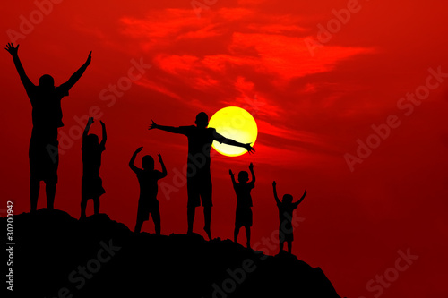 six children jumping mountain sunset