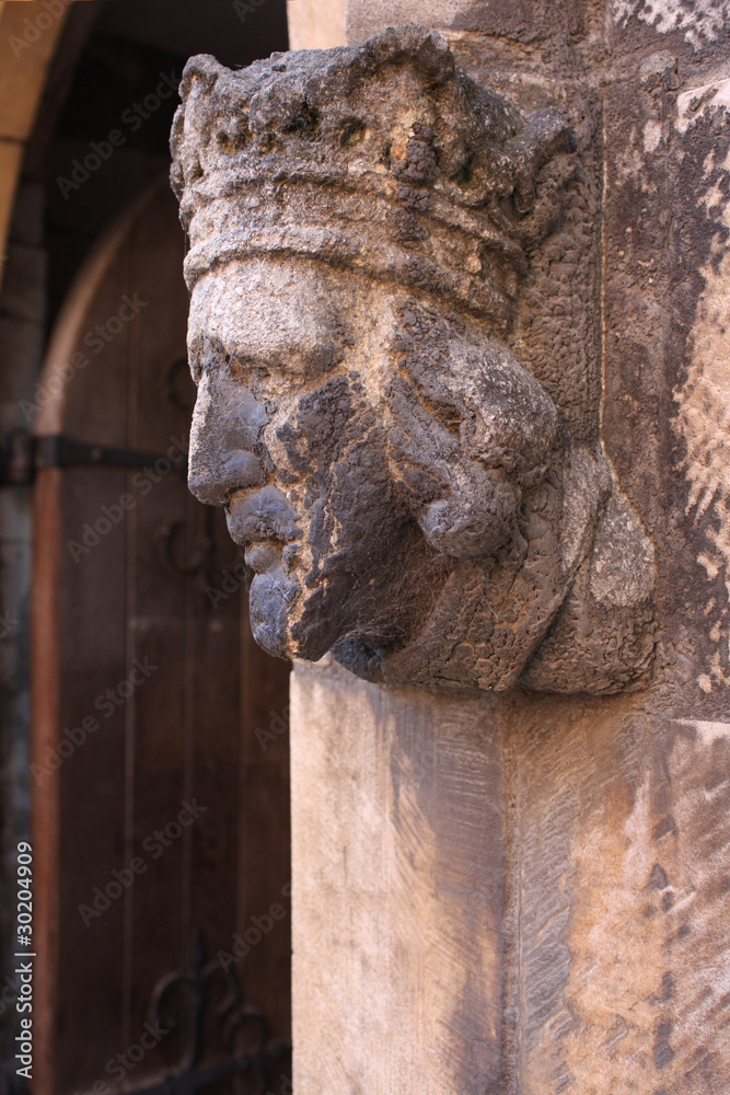 Stone statue of a king’s face on the wall