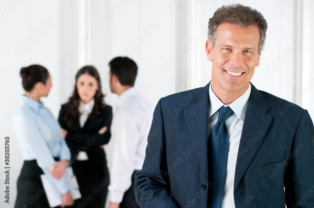 Happy smiling business man with colleagues Happy smiling business man with colleagues
