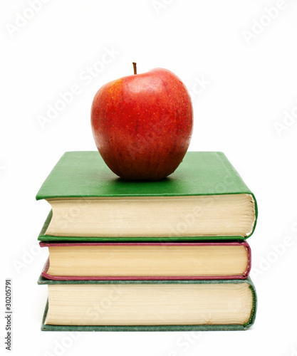 red apple on a book stack