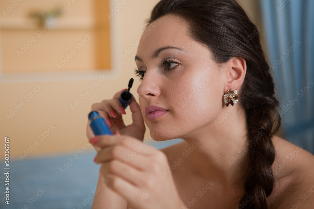 Young beautiful woman doing makeup. Young beautiful woman doing makeup.