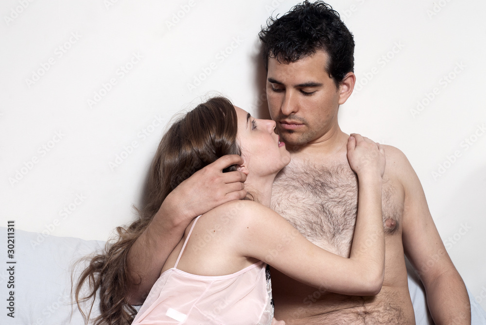 intimate young couple during foreplay in bed intimate young couple during foreplay in bed