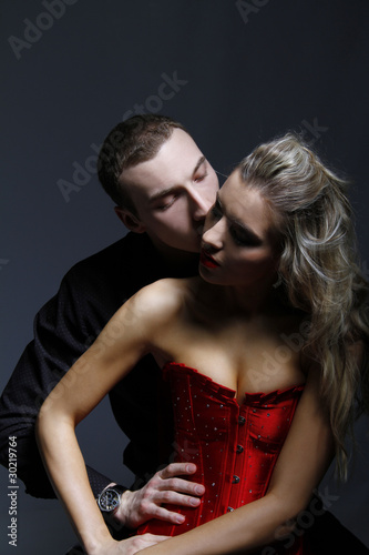 man kissing woman in her neck