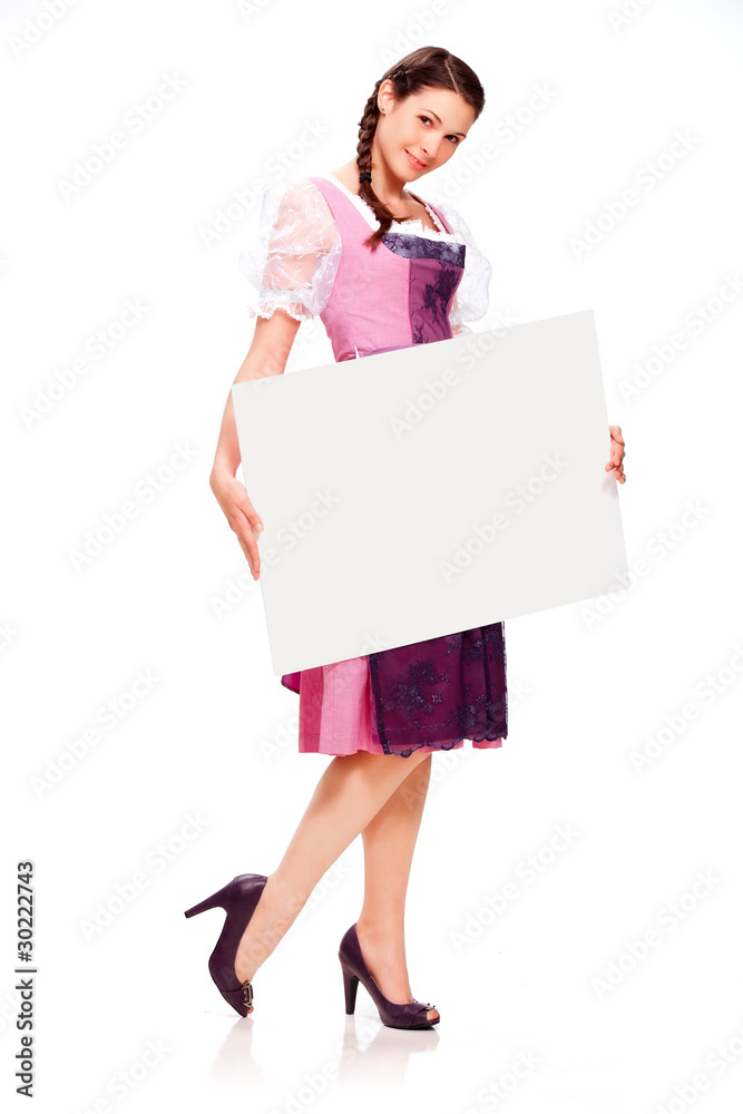 Beautiful young girl with dirndl dress holding white board Beautiful young girl with dirndl dress holding white board