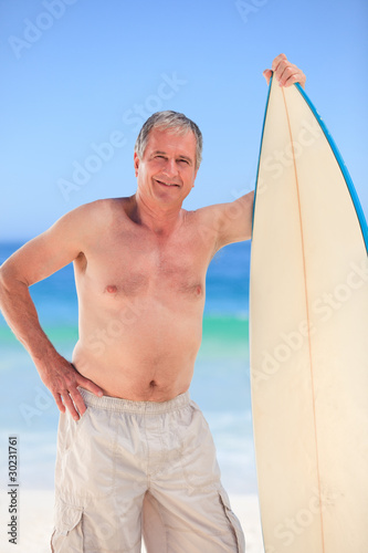 Mature man with his surfboard