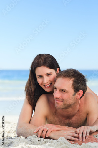 Couple lying down on the beach © WavebreakMediaMicro
