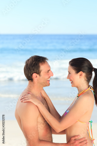 Lovely couple hugging on the beach