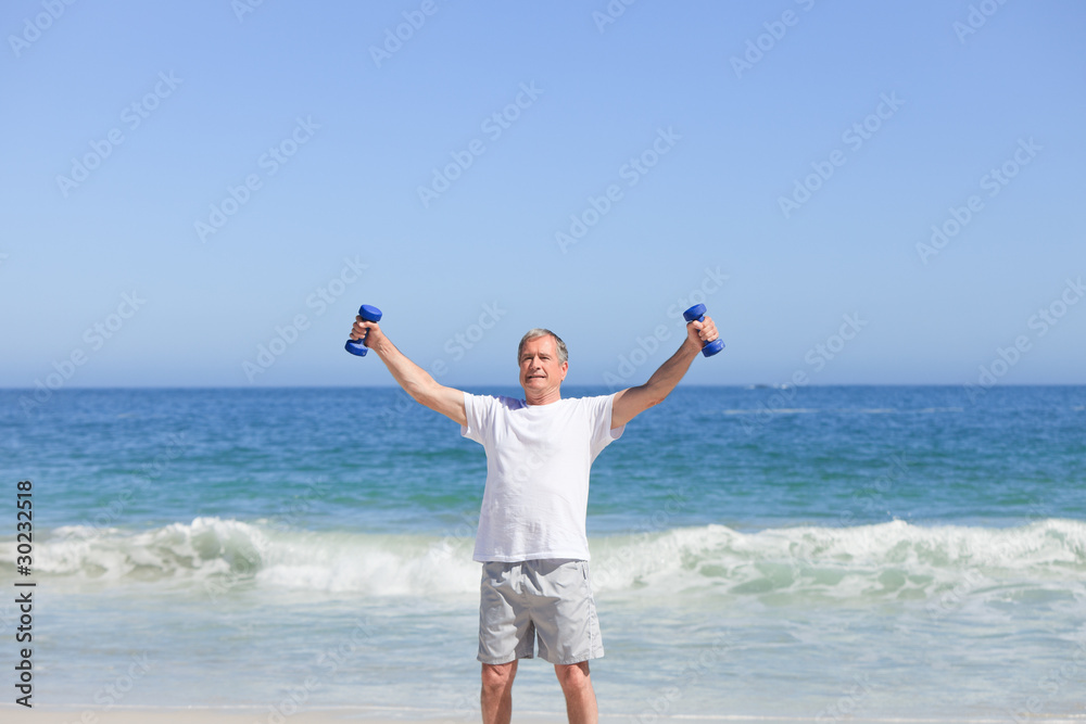Man doing his exercises on the beach
