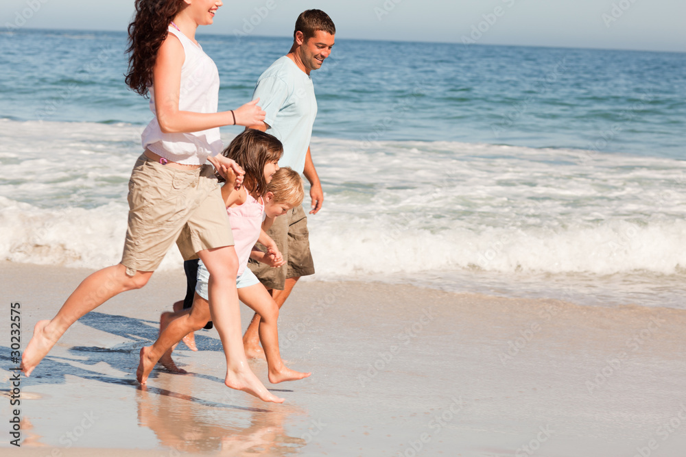Family running on the beach Family running on the beach