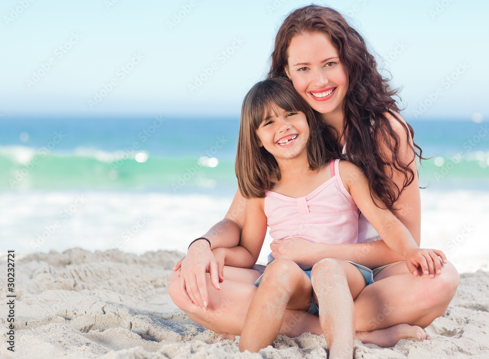 Little girl with her mother at the beach