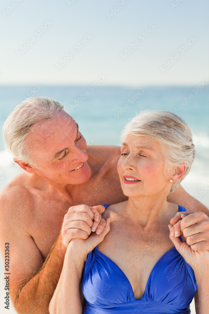 Man hugging his wife at the beach Man hugging his wife at the beach