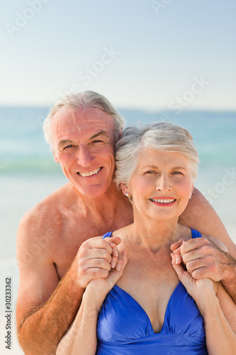 Man hugging his wife at the beach