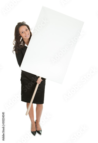 Cheerful businesswomen presenting empty board