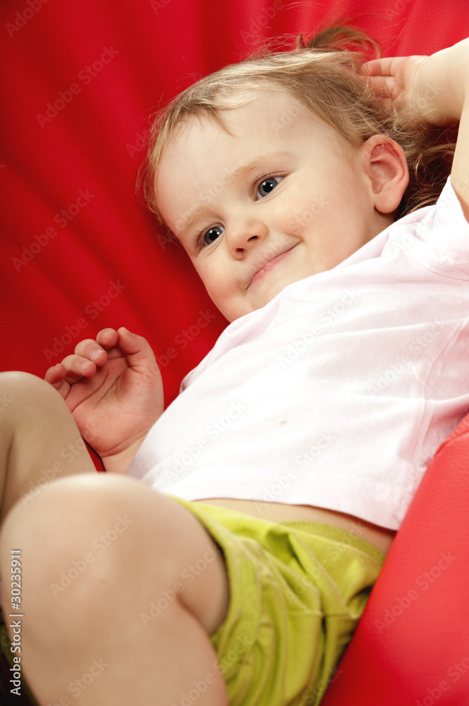 Little baby on red background in studio Little baby on red background in studio