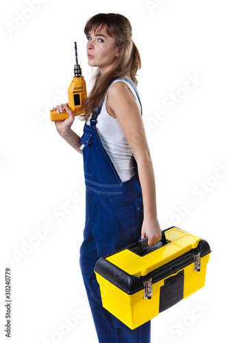 Pretty woman in coveralls with the drill and case