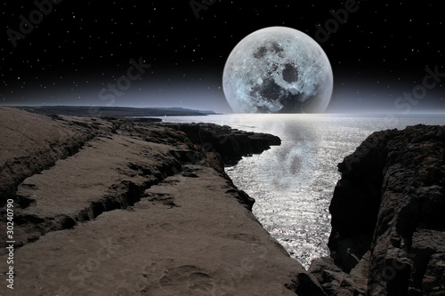 Fototapeta Naklejka Na Ścianę i Meble -  shimmering moon and boulders in rocky burren landscape