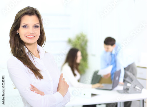 Portrait of a cute business woman with colleagues at the