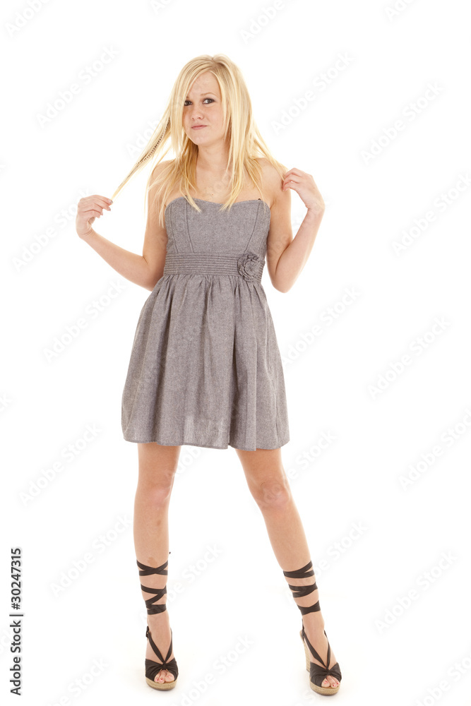 Woman gray dress play with hair Woman gray dress play with hair