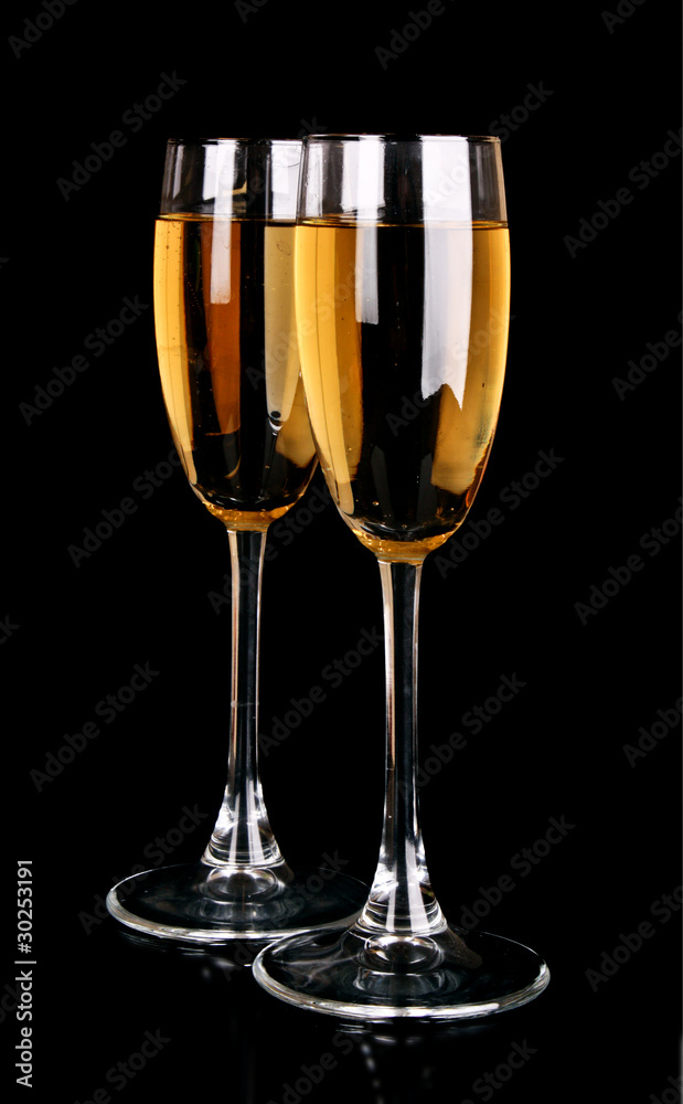 Glasses with champagne on black background