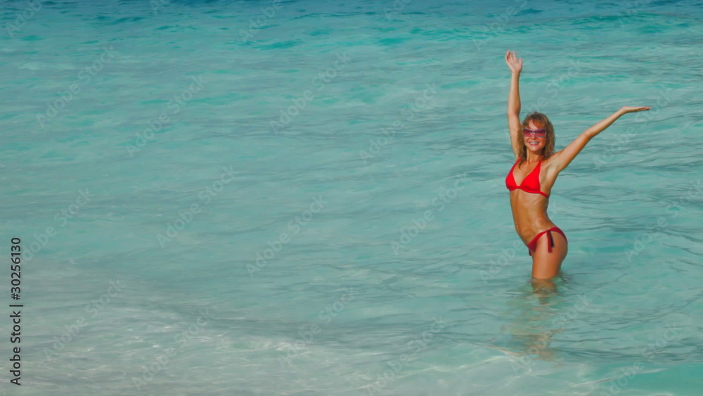 woman practices yoga at sunset