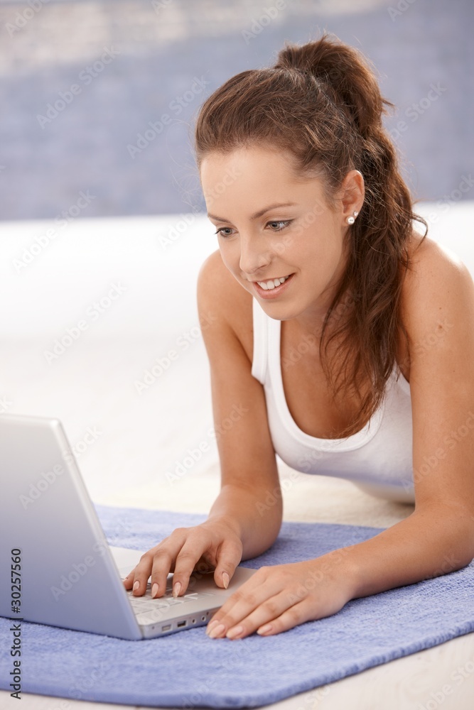 Attractive young girl using laptop at home Attractive young girl using laptop at home